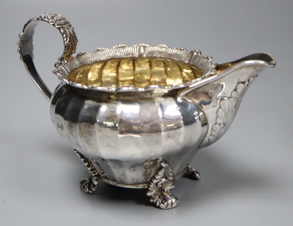 A George IV silver cream jug, London 1823 and an oval half-fluted tea caddy, approx 15oz